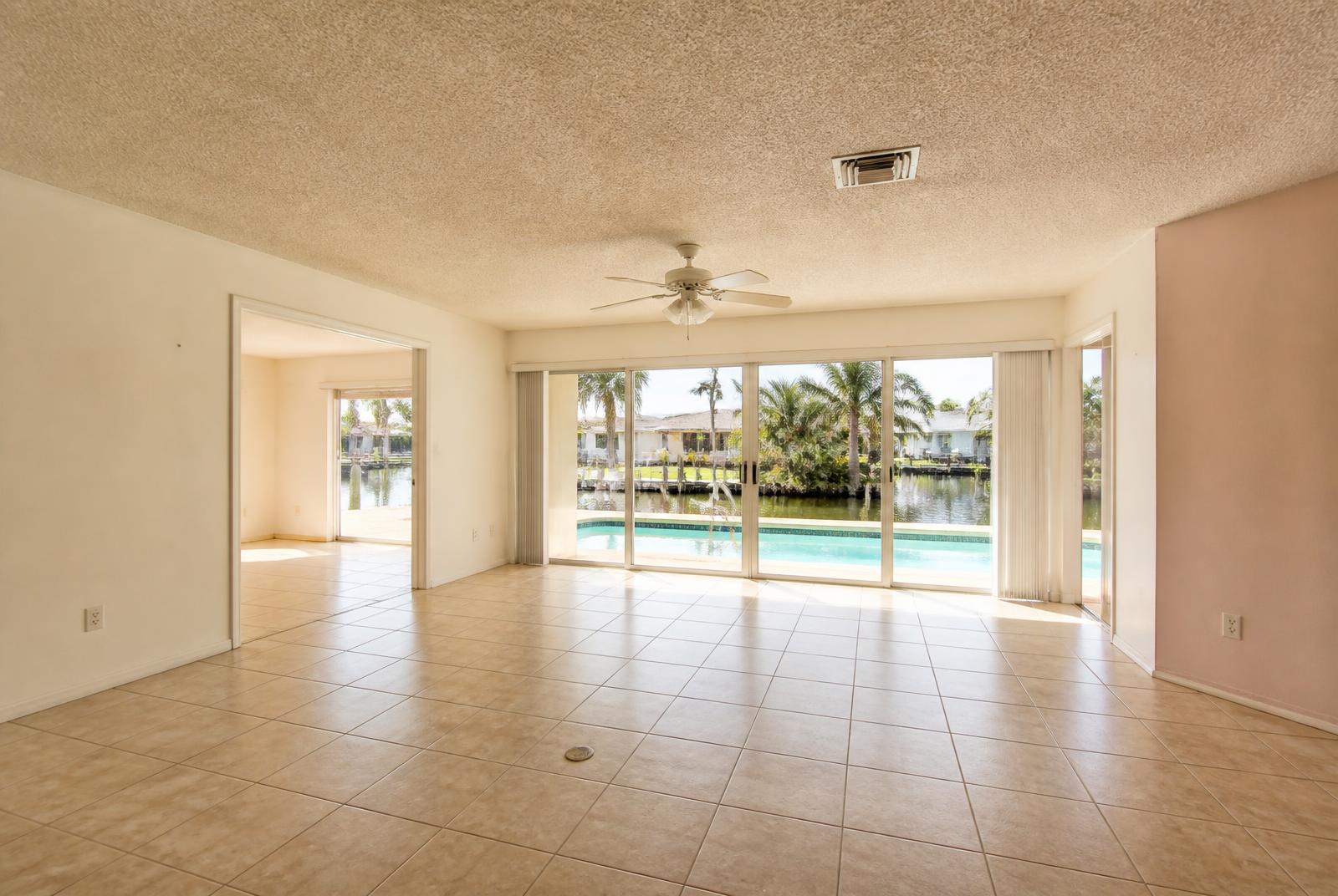 Living room with sliding doors to the pool and canal